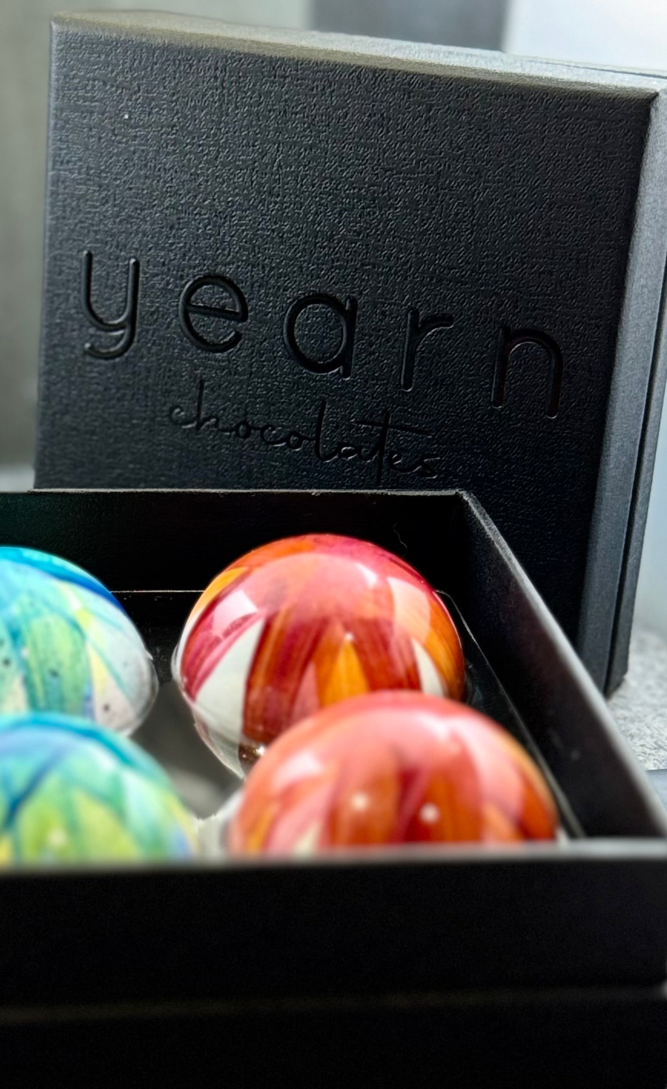 Box of Yearn chocolates with marbled chocolate bonbons