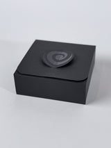 Yearn box in its black gift wrap, closed with the spiral clasp